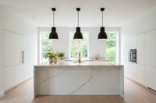 Modern matte black pendant lights over a white marble kitchen island with warm ambient lighting